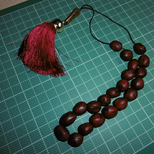 Handmade komboloi with 22 nutmeg beads, tassel, and gold emblem new