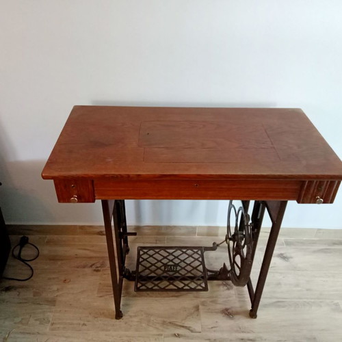 Antique sewing machine used with furniture and accessories