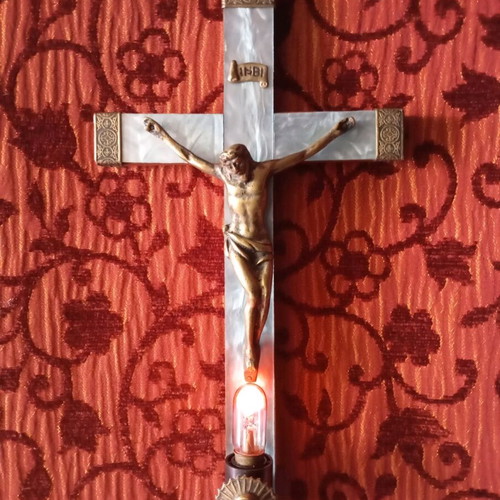 Old wooden crucifix used with bronze and light