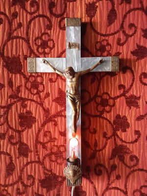 Old wooden crucifix used with bronze and light