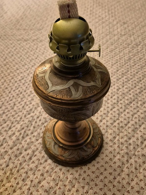 Brass antique oil lamp used with decorative engravings