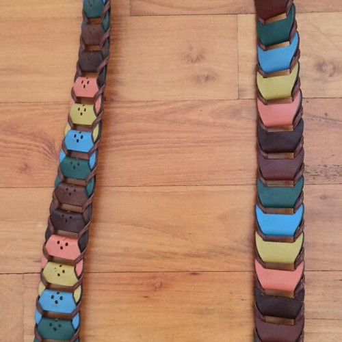 Colorful woven belt in warm shades made of faux leather, like new