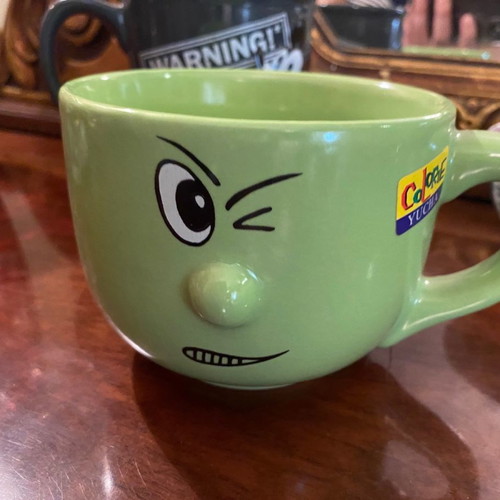 Large mug used with cartoon green handle
