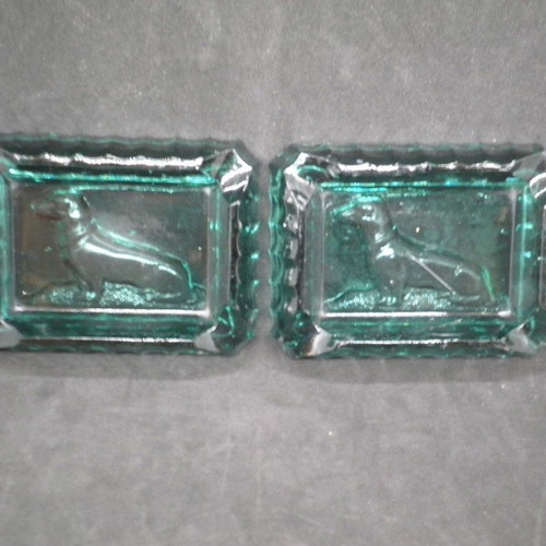 Antique ashtrays pair used with embossed dogs in dark green glass