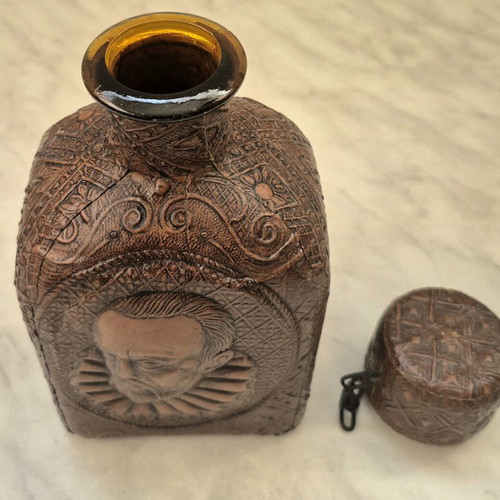 Vintage glass bottle with embossed leather Cervantes & Don Quixote