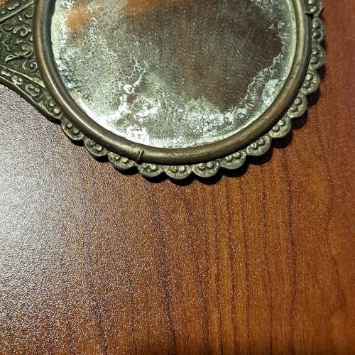 Brass hand mirror used with embossed peacock decoration