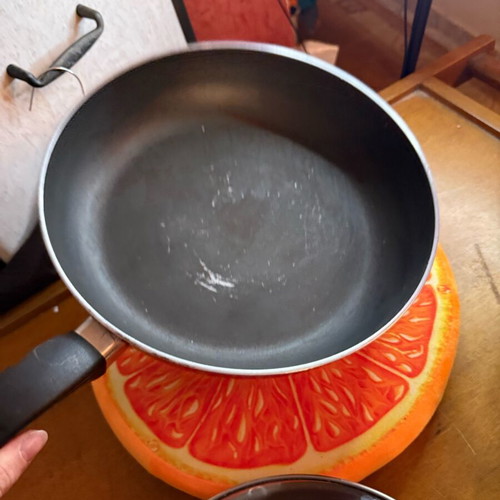 Non-stick frying pan used, red, lightweight and practical