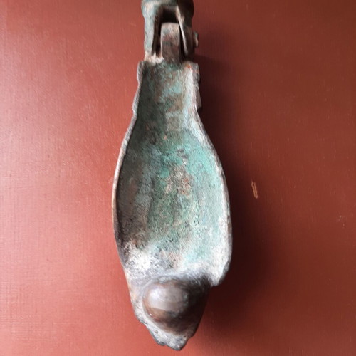 Antique bronze door knocker in hand shape