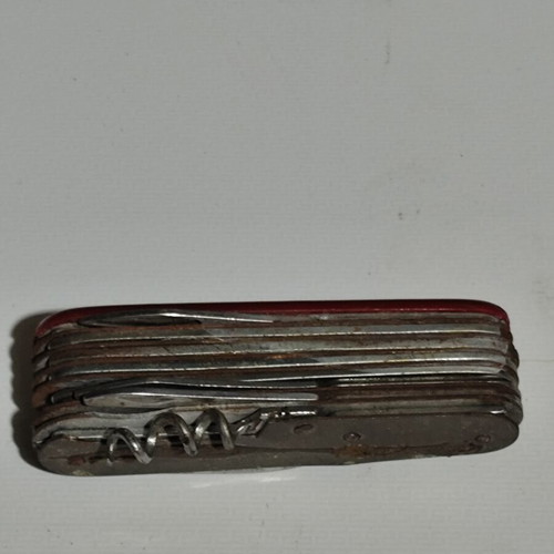 Multitool pocket knife used with red handle and multiple foldable tools
