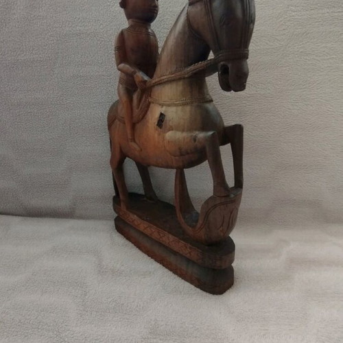 Wooden carving of South Indian man riding horse used