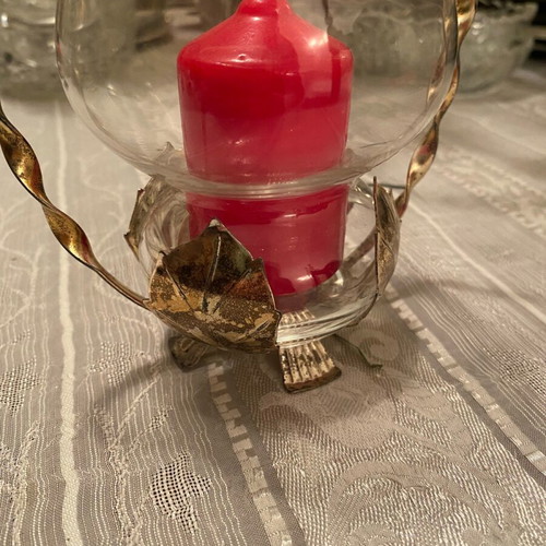 Metal candle holder with glass container used with candle