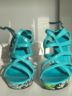 Turquoise high-heel sandals with floral platform and straps used