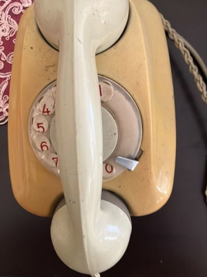 Rotary retro telephone used, beige-green