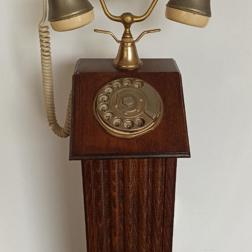 Antique hotel telephone used, wooden column with brass supports