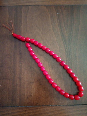Bakelite worry beads used, coral color with silk tassels