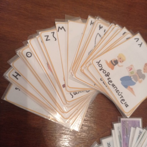 Educational laminated cards with alphabet, money, and numbers