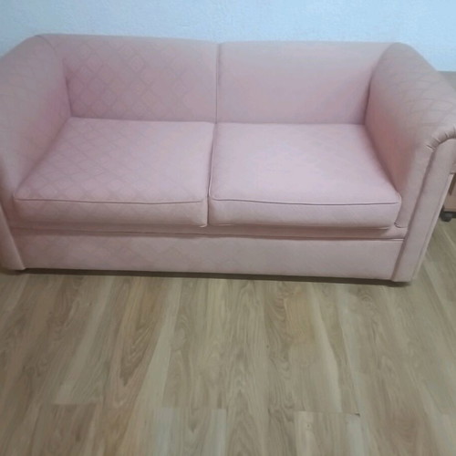Vintage two-seater sofa used, salmon color in very good condition