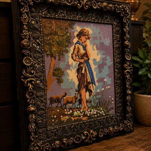Old embroidery in wooden frame with rural scene