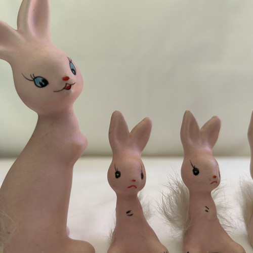 Vintage ceramic pink bunny family figurines with decorative Easter egg