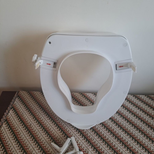 Toilet seat used, raised for adults