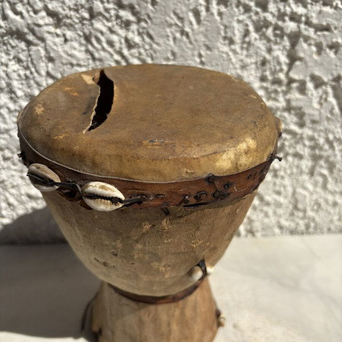 Handmade wooden drum used, African style with leather membrane and shells