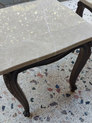Vintage side tables pair with natural marble used