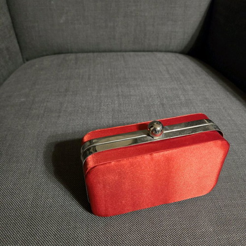 Red satin bag used with silver details and chain strap
