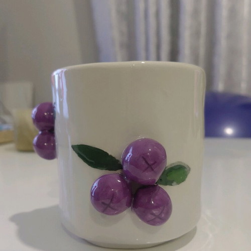 Soy candle with sandalwood scent in handmade ceramic cup