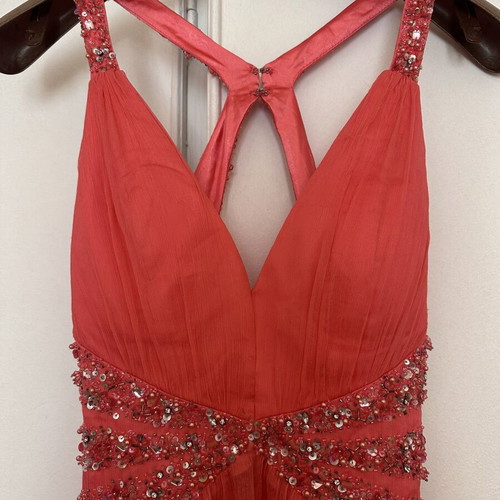 Coral short evening dress with crisscross straps, V neckline, and shiny embroidered beads