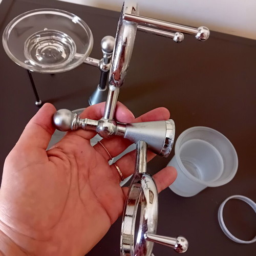 Two sets of inox bathroom accessories with glass and frosted parts