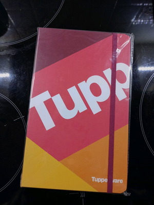 Tupperware notebook new with hard cover and elastic band