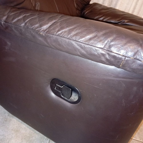 Leather recliner armchair used with wear on seat and footrest