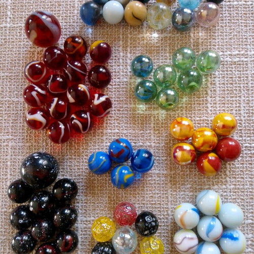 Set of 68 glass marbles used with collectible designs and 2 large shooters