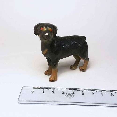 Plastic dog figure used with scratches and marks