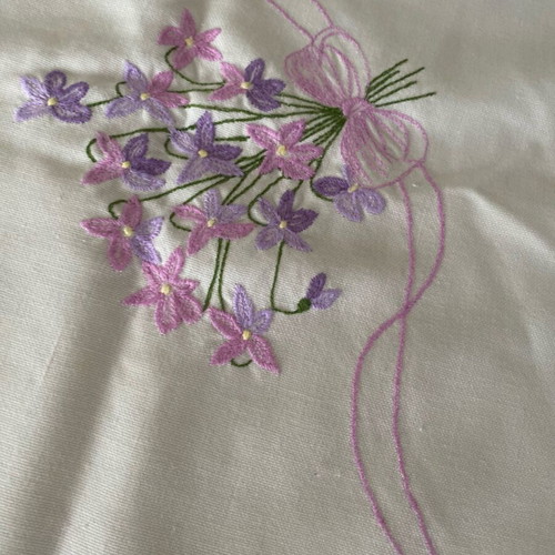 Rectangular table cloth used, white with pink and purple flowers 80x80cm
