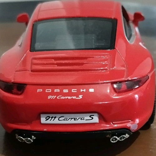 Collectible Porsche Carrera toy car with opening doors like new