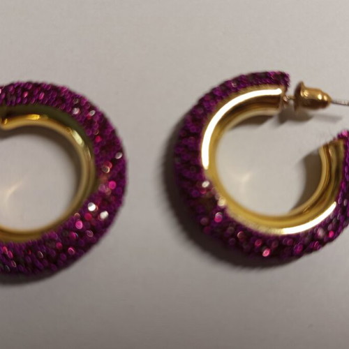 Chunky gold hoop earrings with purple rhinestones, used