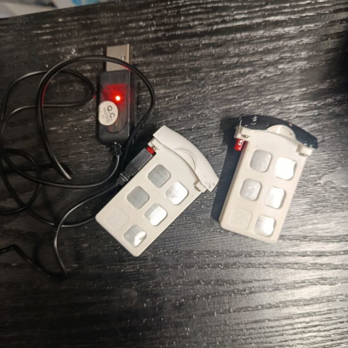 Syma drones used with controllers, two batteries and extra propellers