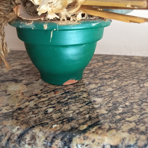 Vintage handmade decorative arrangement with dried stalks used