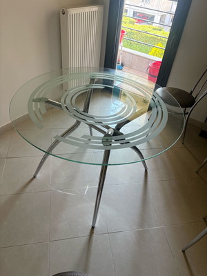 Round glass dining table with metal base