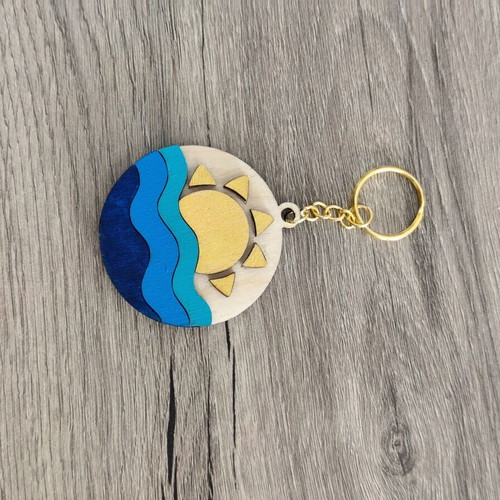 Handmade wooden summer keychain with laser cut sun and waves design