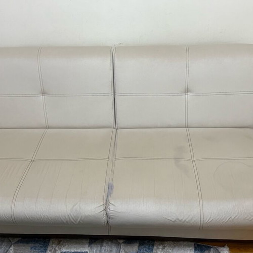 Three-seater sofas used with two stools and storage space