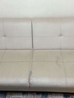Three-seater sofas used with two stools and storage space