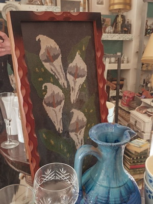 Vintage embroidery lilies in frame used with protective glass
