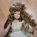 Glass Bride Doll like new with lace dress and hat