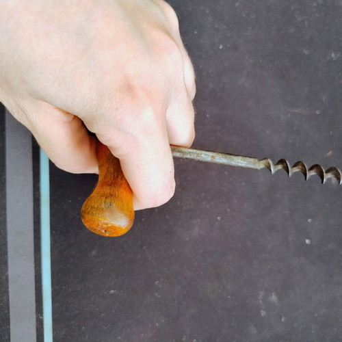 Vintage bottle opener with wooden handle used