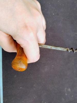 Vintage bottle opener with wooden handle used