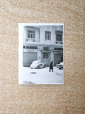 Vintage black and white photo Snowy street with VW Beetle and Kaiti hair salon
