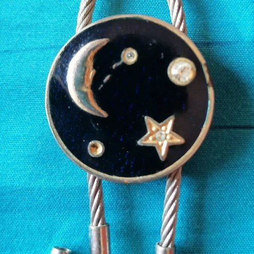 Keychain with moon and star design used, blue and silver