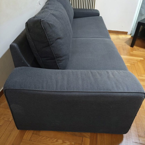 Two-seater fabric sofa used, dark gray color with visible marks